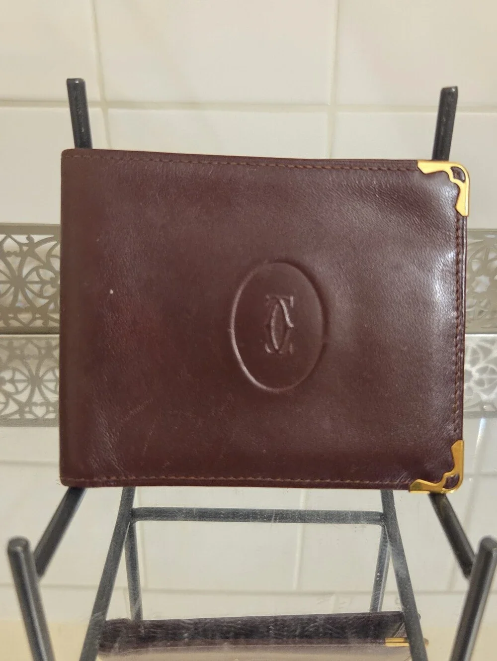 Cartier Leather Bifold Wallet in Deep Maroon with Gold Corner Accents